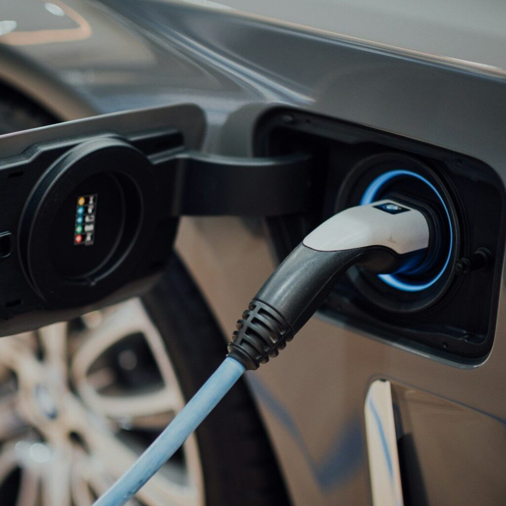Only 16% of Americans Plan to Buy an Electric Vehicle, AAA Survey Finds electric vehicle charging cable plugged into car